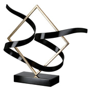 Swing of balance black and gold metal sculpture