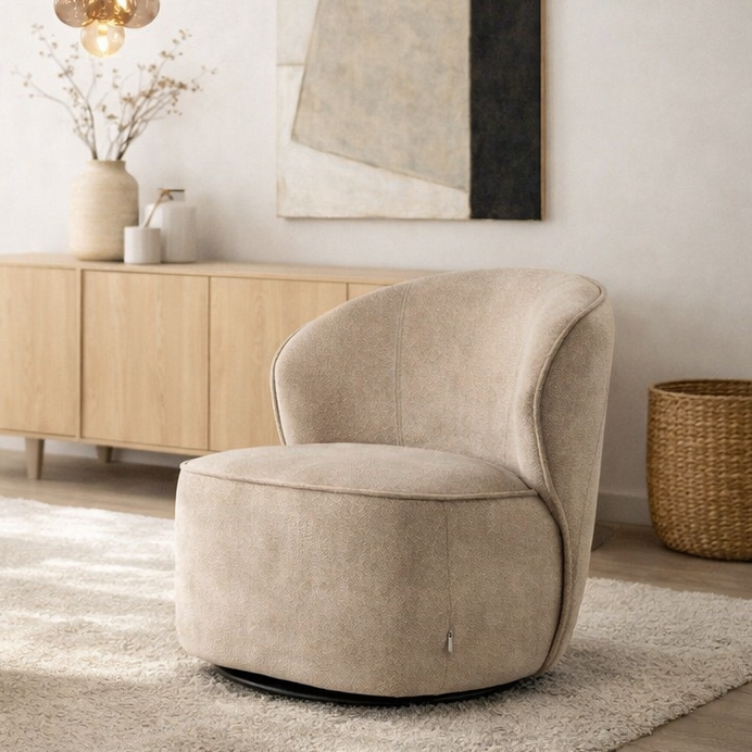 Beige swivel chair in a modern living room setting with wooden cabinet and decorative items.