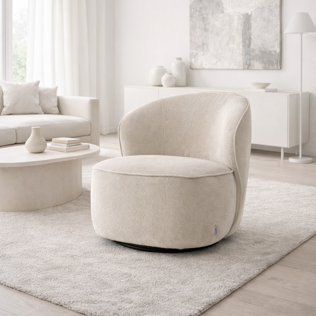 Modern living room with a beige armchair, coffee table, and abstract art on the wall.
