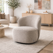 Modern living room with a beige armchair, coffee table, and abstract art on the wall.