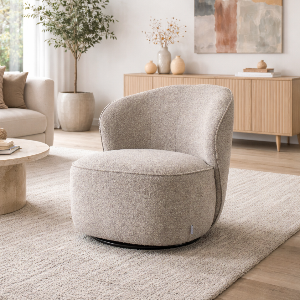 Modern living room with a beige armchair, coffee table, and abstract art on the wall.