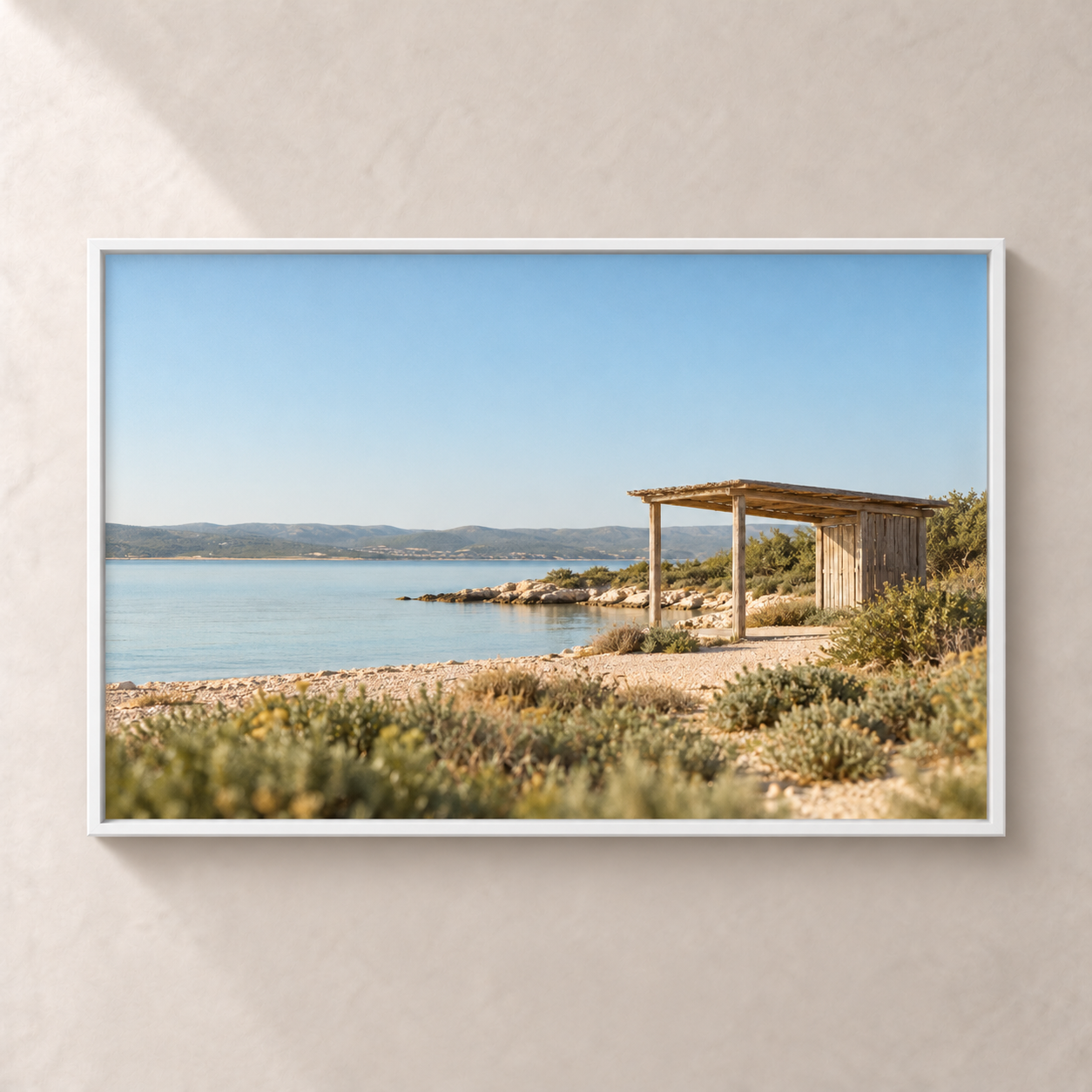 The Quiet Shore horizontal poster in a white frame, front view on a warm neutral wall